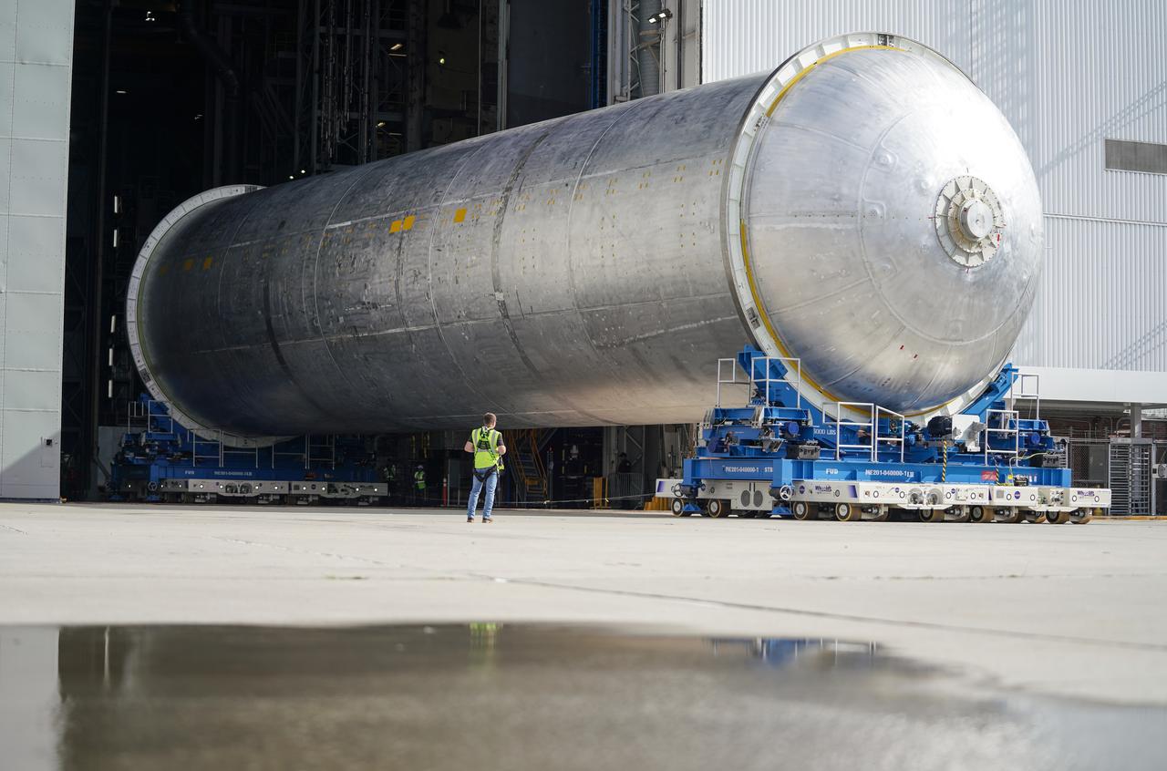 Teams move the core stage liquid hydrogen tank for the Artemis III mission to a priming cell near the Vertical Assembly Building at NASA’s Michoud Assembly Facility in New Orleans Nov. 21. Technichians will sand down and prepare the suface of the tank before coating it in a primer. Primer is applied to the barrel section of the tank by an automated robotic tool, whereas the forward and aft domes are primed manually.   Once priming is complete, technicians with NASA and Boeing, the SLS core stage prime contractor, will apply a foam-based thermal protection system, which protects the propellant tank from the extreme temperatures it will face during launch and flight while also regulating the super-chilled propellant within it. The propellant tank is one of five major elements that make up the 212-foot-tall rocket stage. The core stage, along with its four RS-25 engines, produce two million pounds of thrust to help launch NASA’s Orion spacecraft, astronauts, and supplies beyond Earth’s orbit and to the lunar surface for Artemis.   